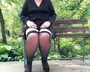 Naughty milf in pantyhose pissing in the park on a bench rear view