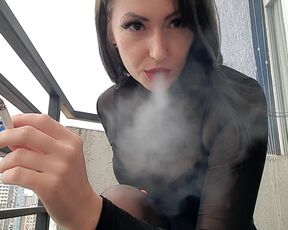 Dominatrix smokes sexy and blows smoke at you